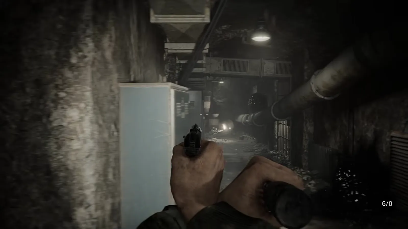 Player hands holding a flashlight in the left hand and a pistol in the right hand in a dim indoor corridor